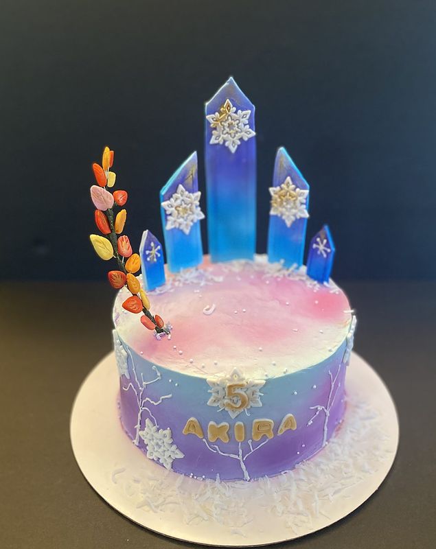 Lavender ombré birthday cake topped with blue crystal castle spires