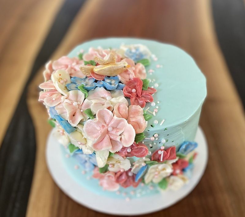 Mint cake covered with piped pastel buttercream flowers